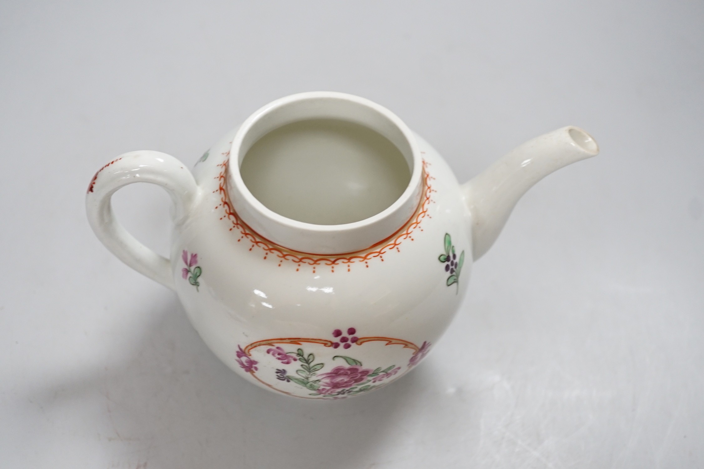 An 18th century Worcester teapot and cover painted in Chinese export style with flowers in an oval panel. 16cm tall